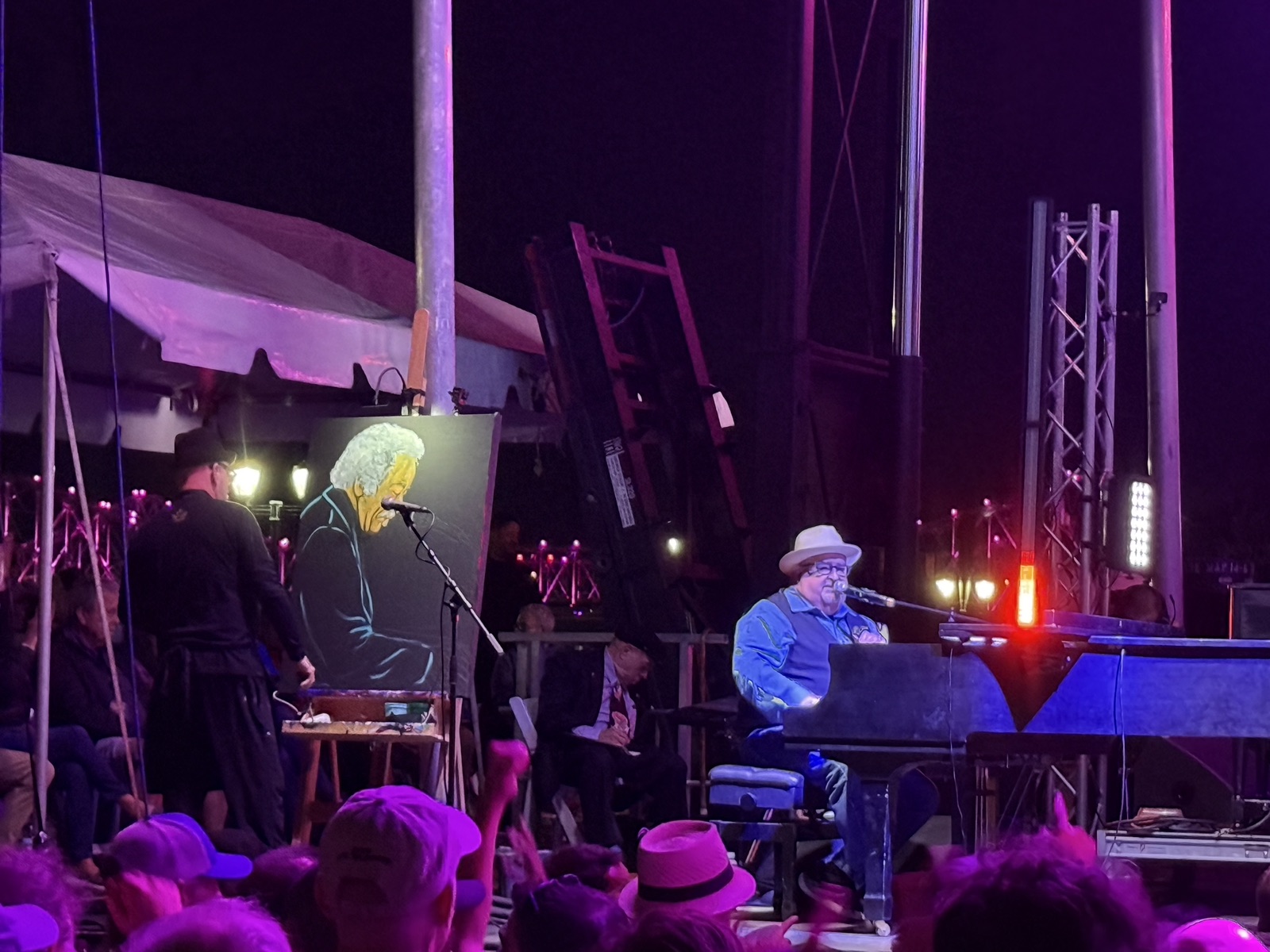 Frenchy painting on the Funk Fest main stage during the Allen Toussaint Tribute, with the piano and crowd in front of him