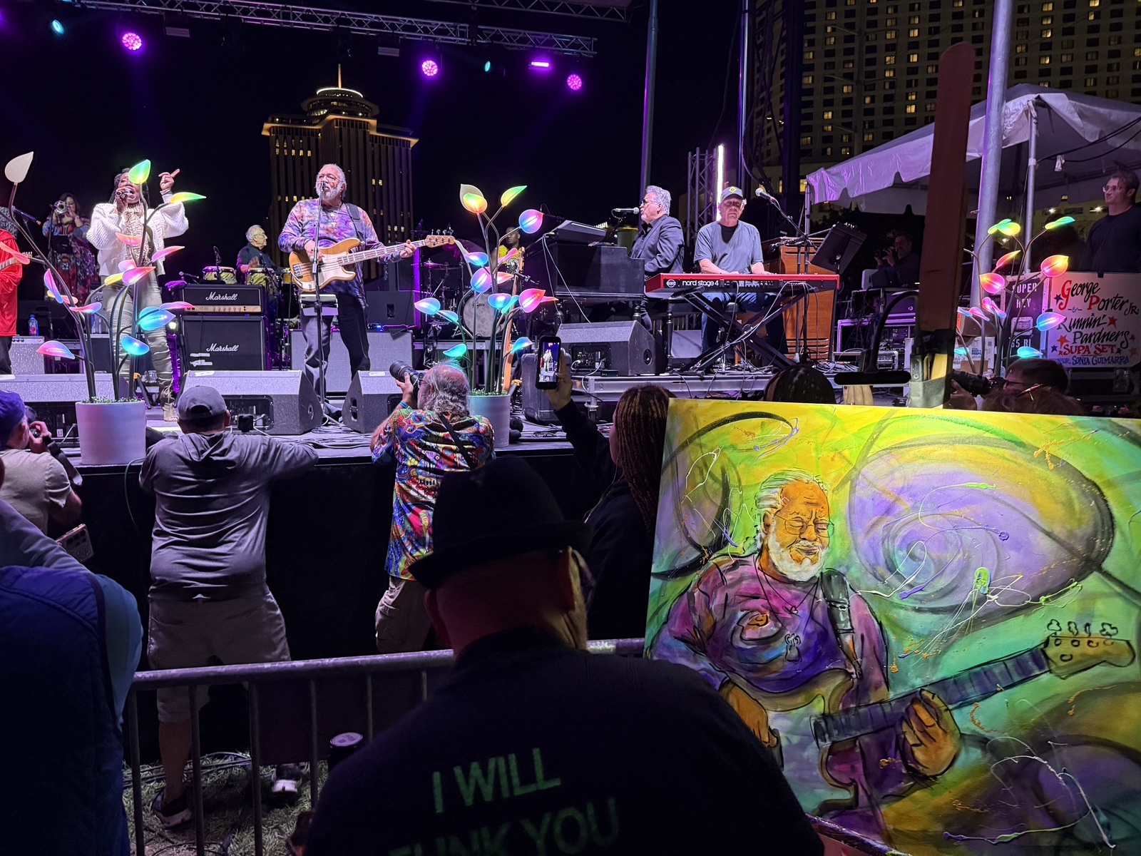 Frenchy's George Porter Jr painting in the crowd during the closing set, with the band on stage behind it