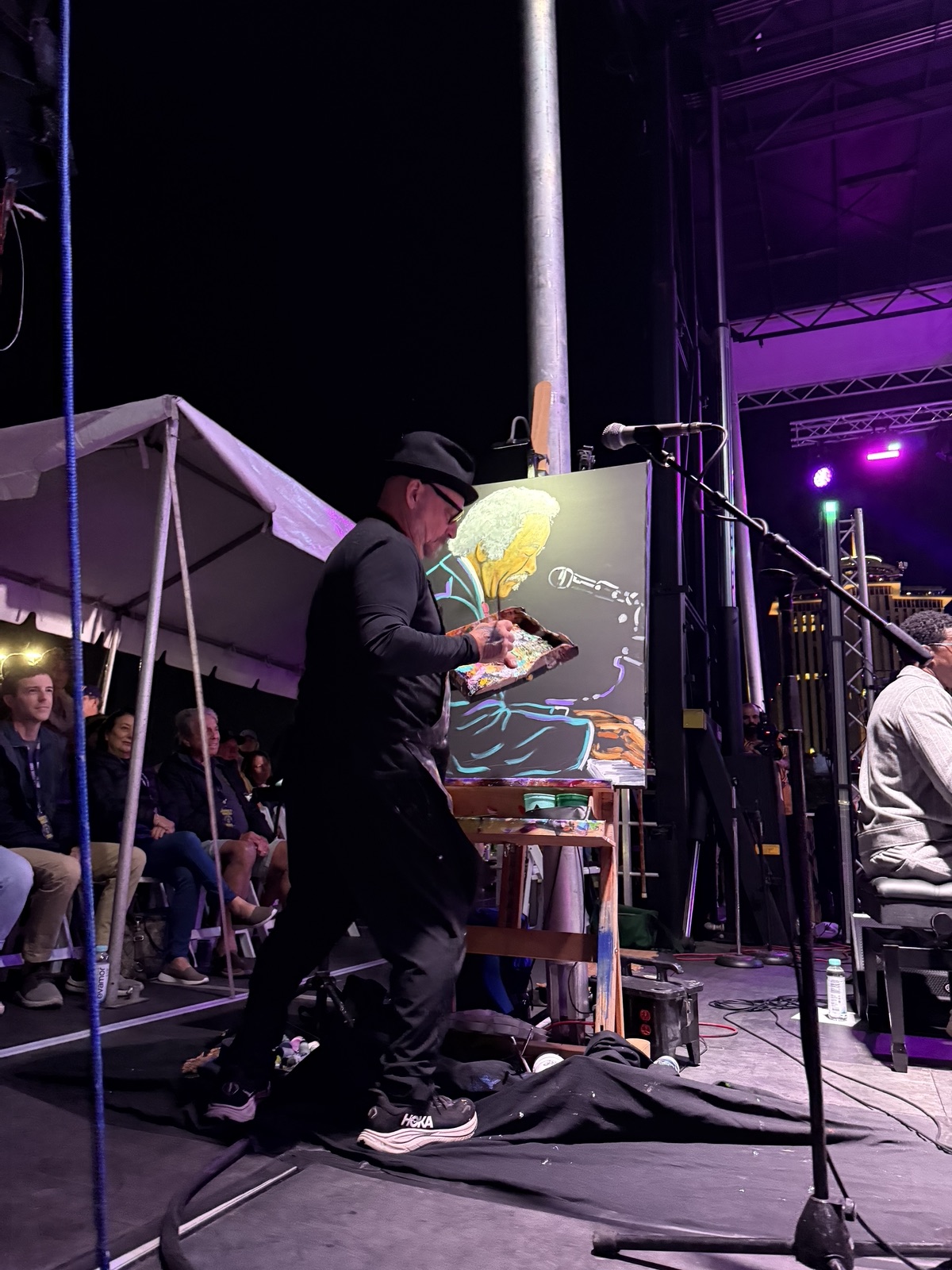 Frenchy at his easel on the main stage, working on the Allen Toussaint painting under the stage lights
